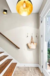 a view of a balcony with chairs and wooden floor