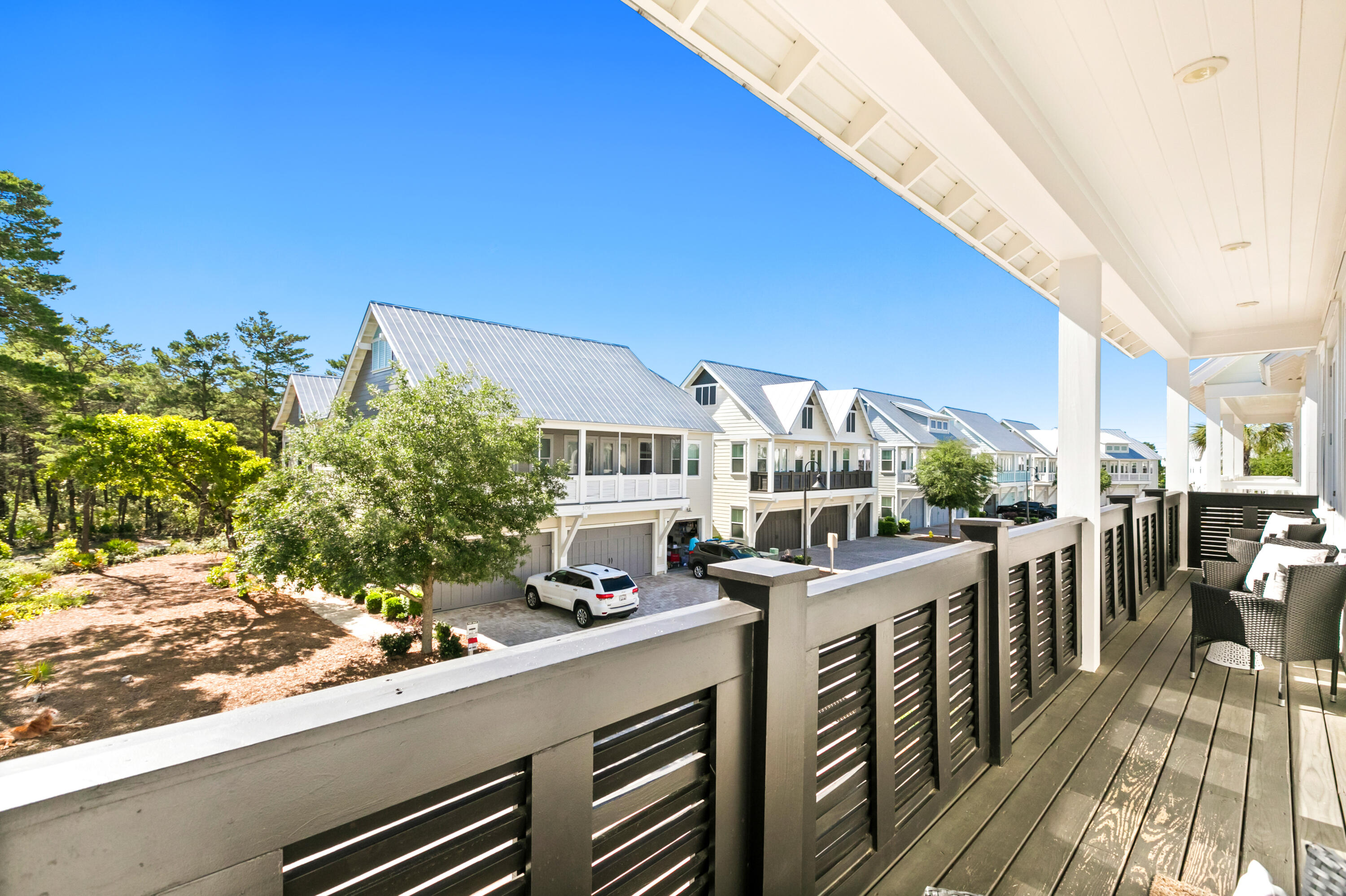 111 East Milestone Drive, Unit C Inlet Beach, FL 32461 - Photo 28 of 37 a view of a balcony with chairs and wooden floor