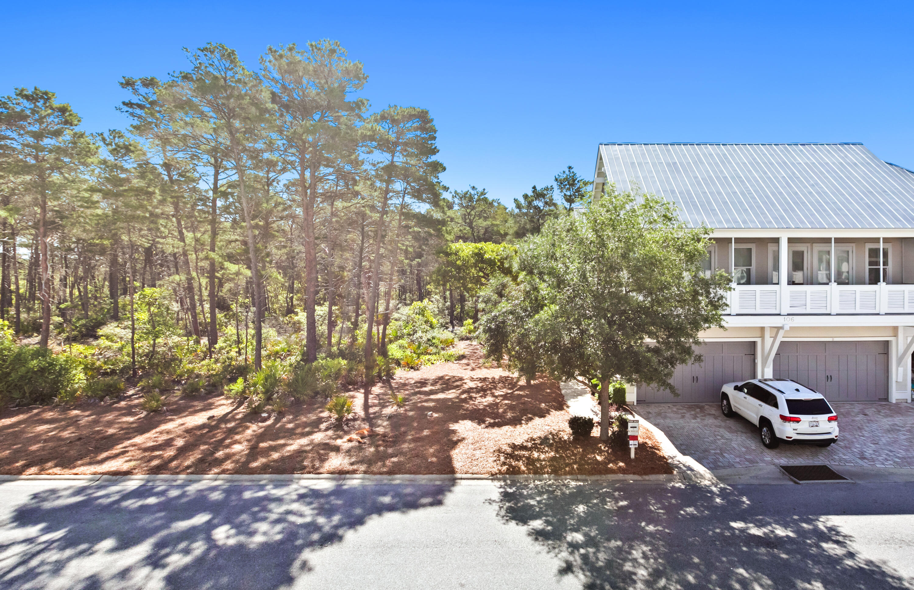 111 East Milestone Drive, Unit C Inlet Beach, FL 32461 - Photo 30 of 37 a view of a backyard with table and chairs and a fire pit