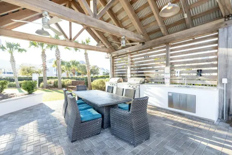 a group of people sitting in a yard in front of retail shop