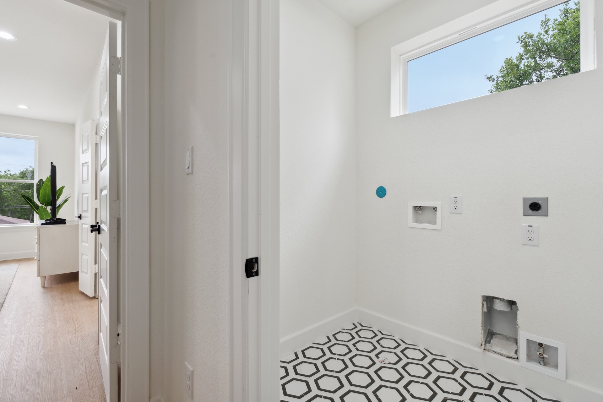 6408 Foster Street Houston, TX 77021 - Photo 30 of 39 Second-floor laundry room — statement geometric floor tile, transom accent window for natural light, and full washer/dryer hookups.