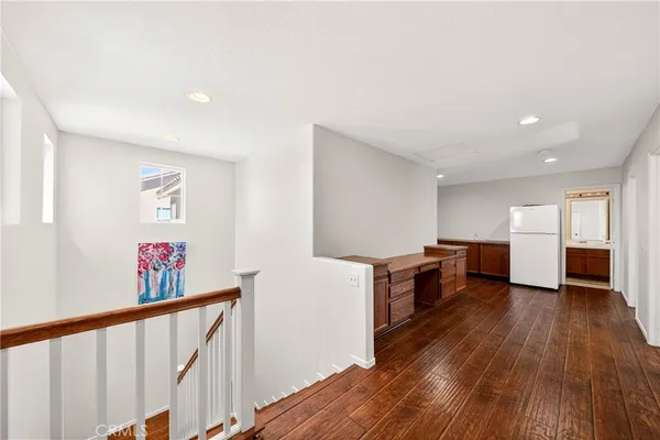 a big room with wooden floor and windows