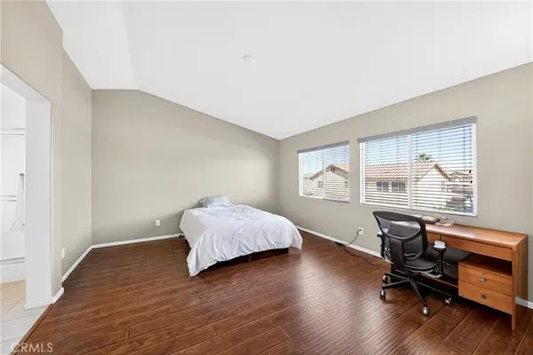 a bedroom with a bed and a chair