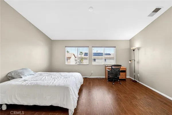 a view of workspace with wooden floor and windows