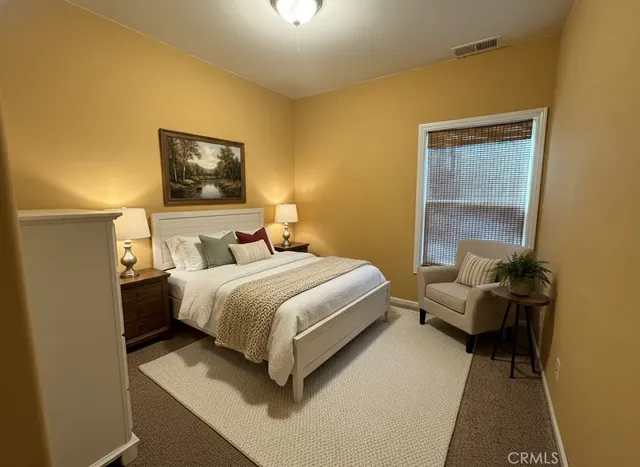 a bedroom with a bed and a painting on the wall