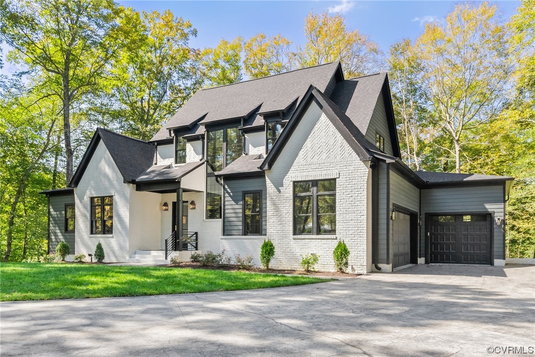 a front view of a house with a garden and plants