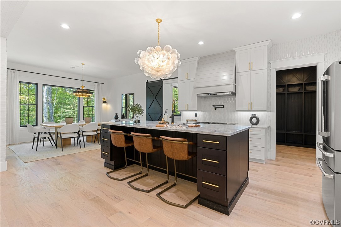 8576 Barrique Road New Kent, VA 23124 - Photo 14 of 50 a kitchen with a counter space dining table and chairs