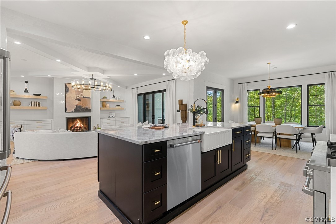 8576 Barrique Road New Kent, VA 23124 - Photo 15 of 50 a large kitchen with kitchen island stainless steel appliances a table and a chandelier