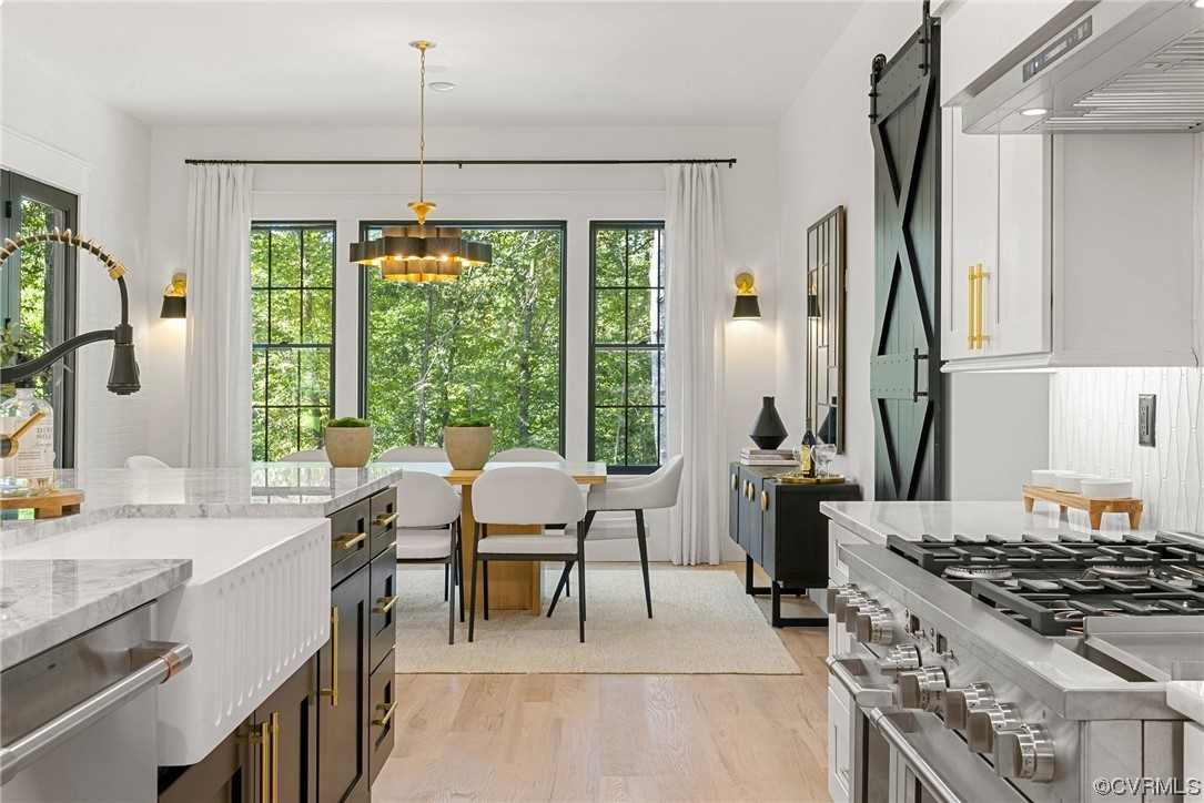 8576 Barrique Road New Kent, VA 23124 - Photo 16 of 50 a kitchen with a stove a sink and a refrigerator