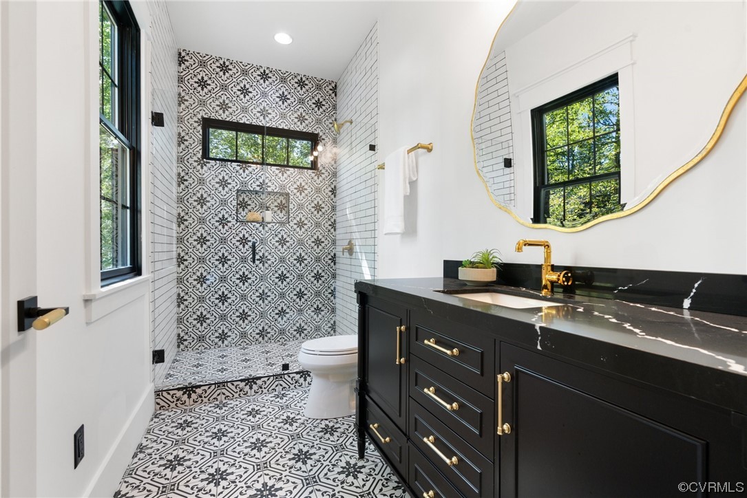 8576 Barrique Road New Kent, VA 23124 - Photo 21 of 50 a bathroom with a sink a mirror and shower