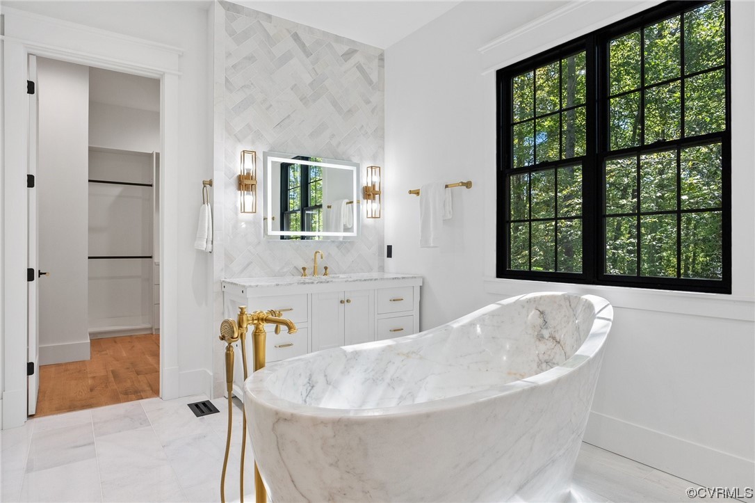 8576 Barrique Road New Kent, VA 23124 - Photo 26 of 50 a bath tub sitting in a bathroom next to a window