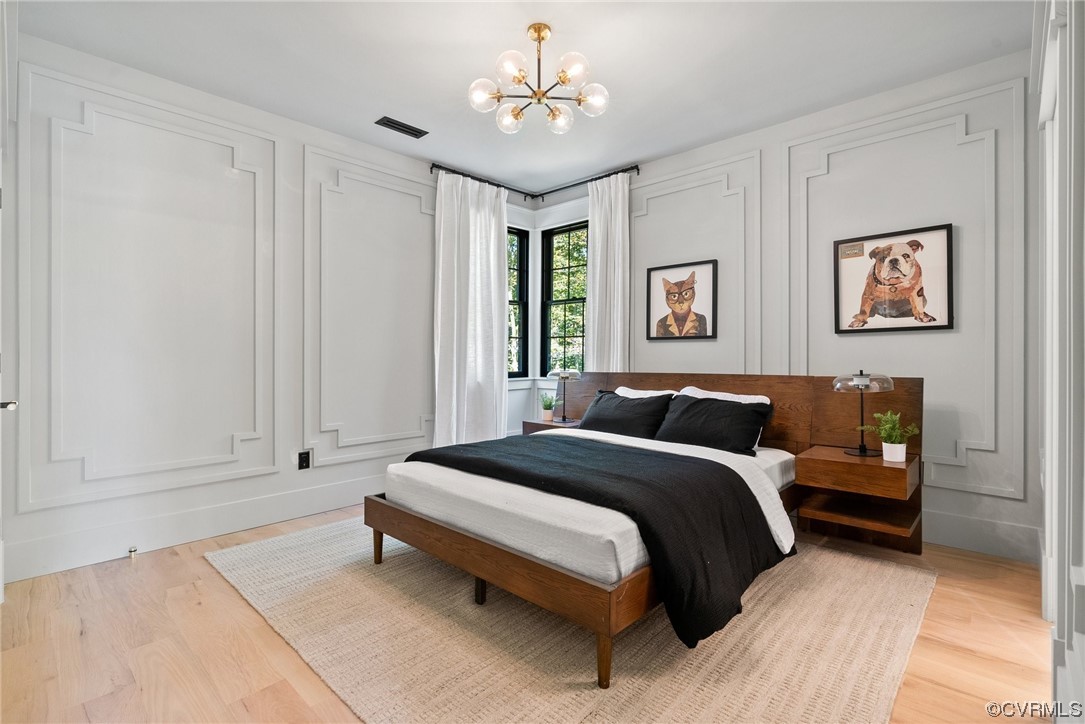 8576 Barrique Road New Kent, VA 23124 - Photo 37 of 50 a bedroom with a bed and a chandelier