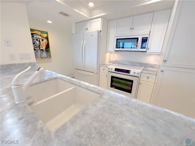a kitchen with a sink stainless steel appliances and cabinets