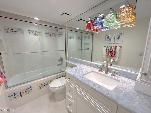 a bathroom with a sink a vanity a mirror and a toilet