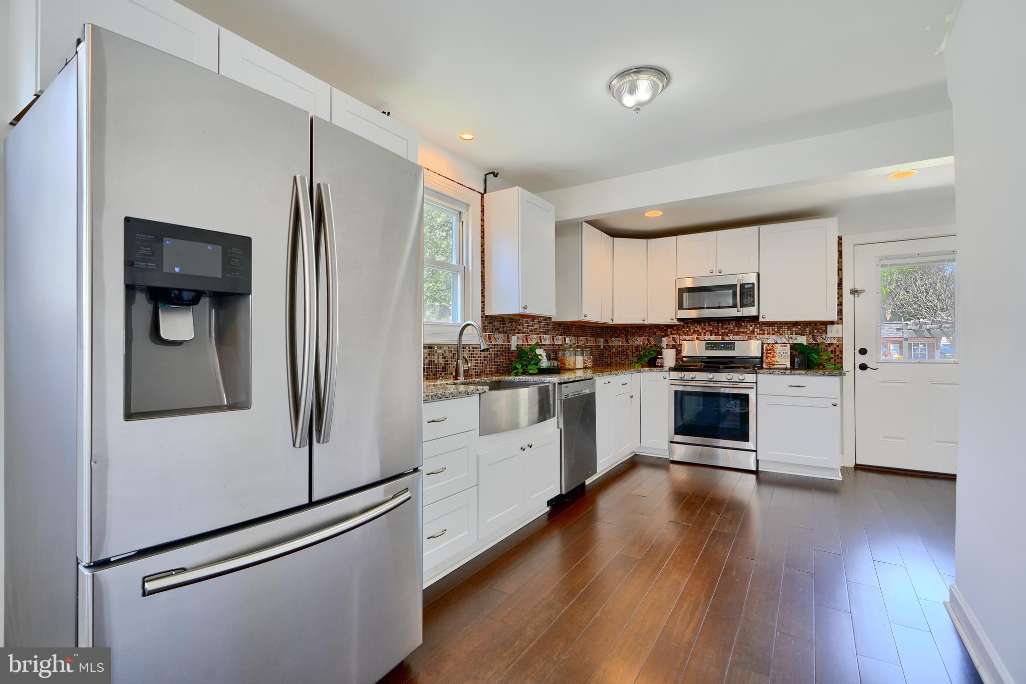 294 Stillwater Road Baltimore, MD 21221 - Photo 12 of 40 a kitchen with granite countertop white cabinets and white appliances