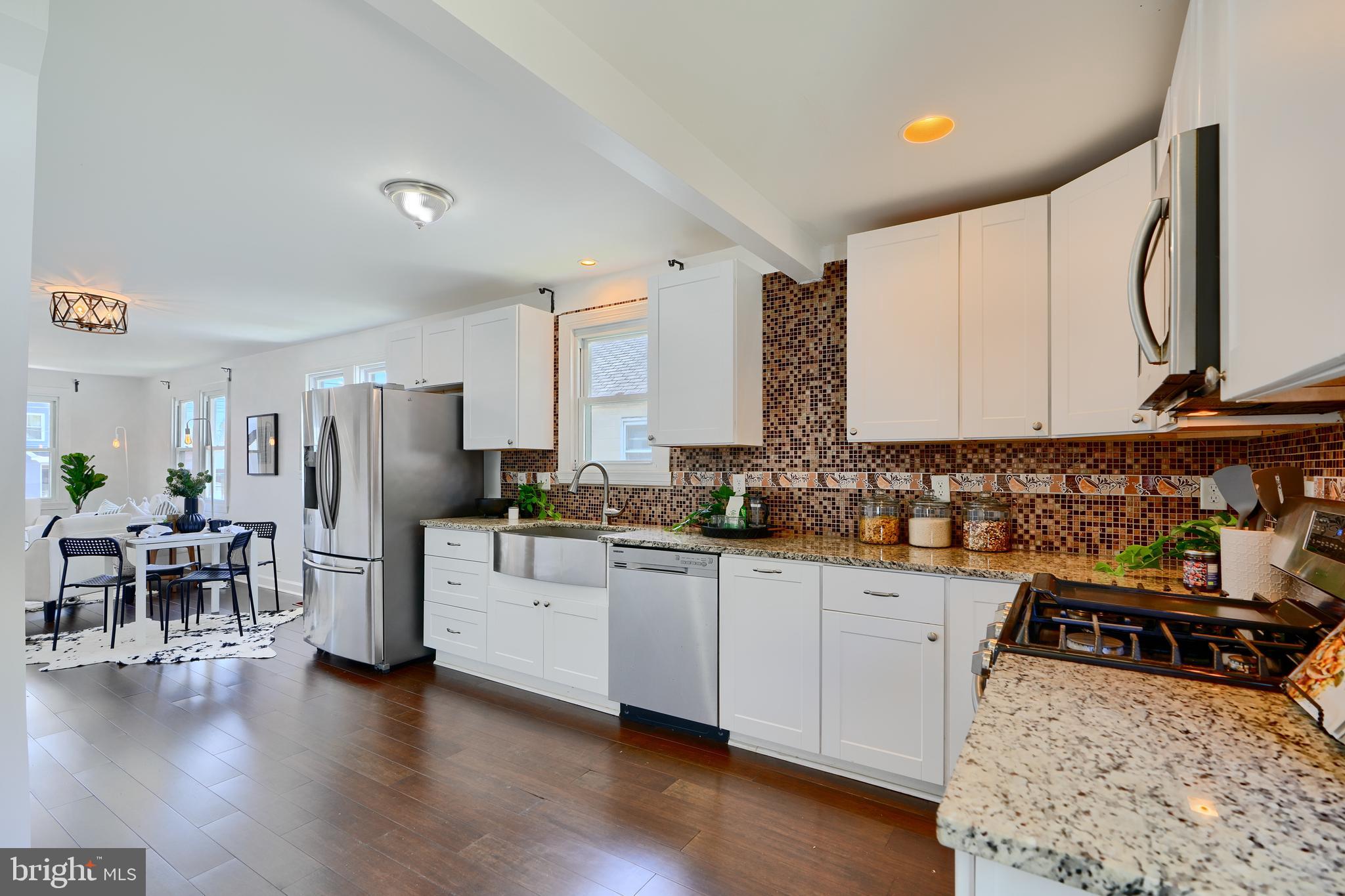 294 Stillwater Road Baltimore, MD 21221 - Photo 14 of 40 a kitchen with granite countertop a sink stove and refrigerator