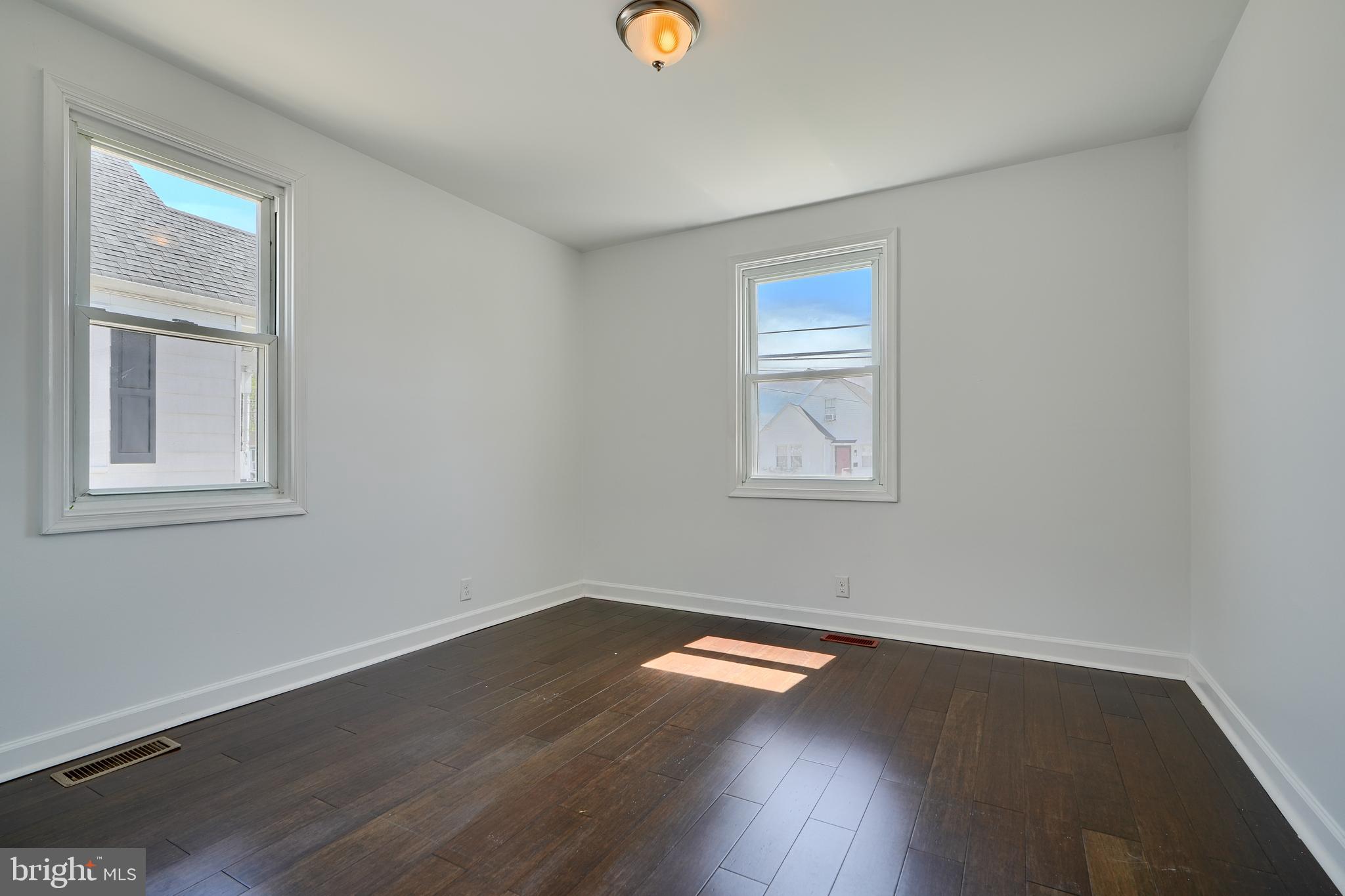 294 Stillwater Road Baltimore, MD 21221 - Photo 22 of 40 a view of empty room with wooden floor and fan