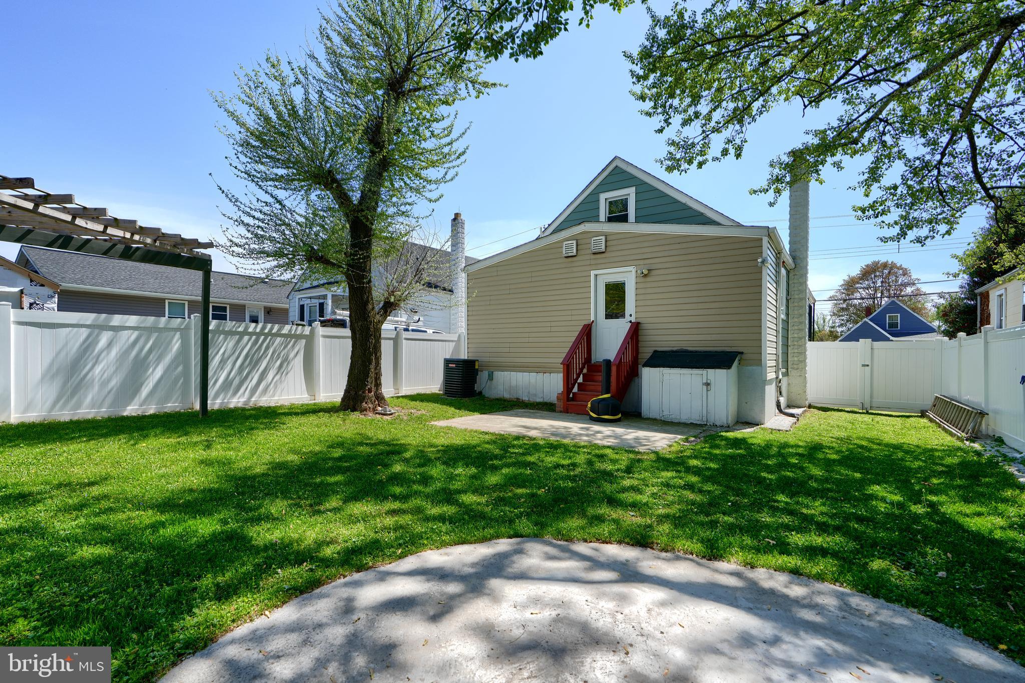 294 Stillwater Road Baltimore, MD 21221 - Photo 40 of 40 a view of a house with a yard and a large tree