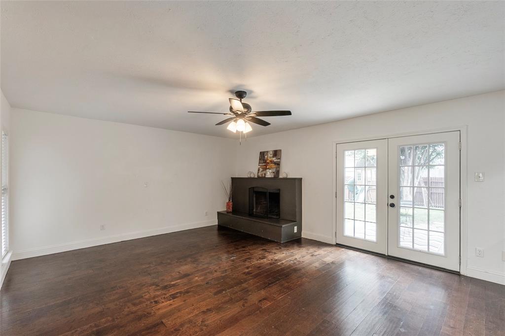 2004 White Ash Road Carrollton, TX 75007 - Photo 12 of 40 Family room with fireplace and french doors to back patio