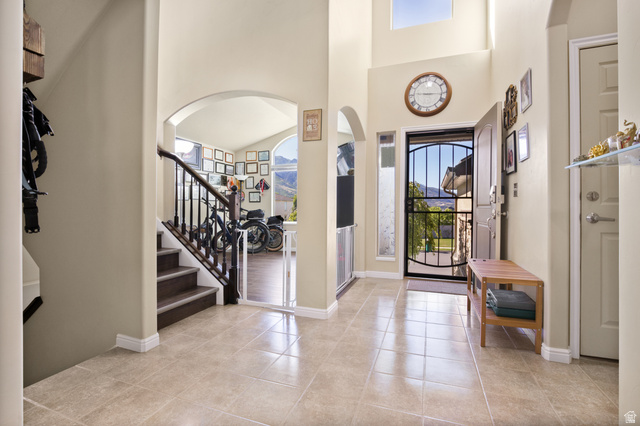 2005 Redtail Way Layton, UT 84040 - Photo 5 of 37 Two-story entryway featuring tile flooring, vaulted ceilings, and a front entry door with an iron security gate