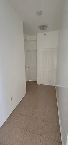 a kitchen with a refrigerator a stove and a sink