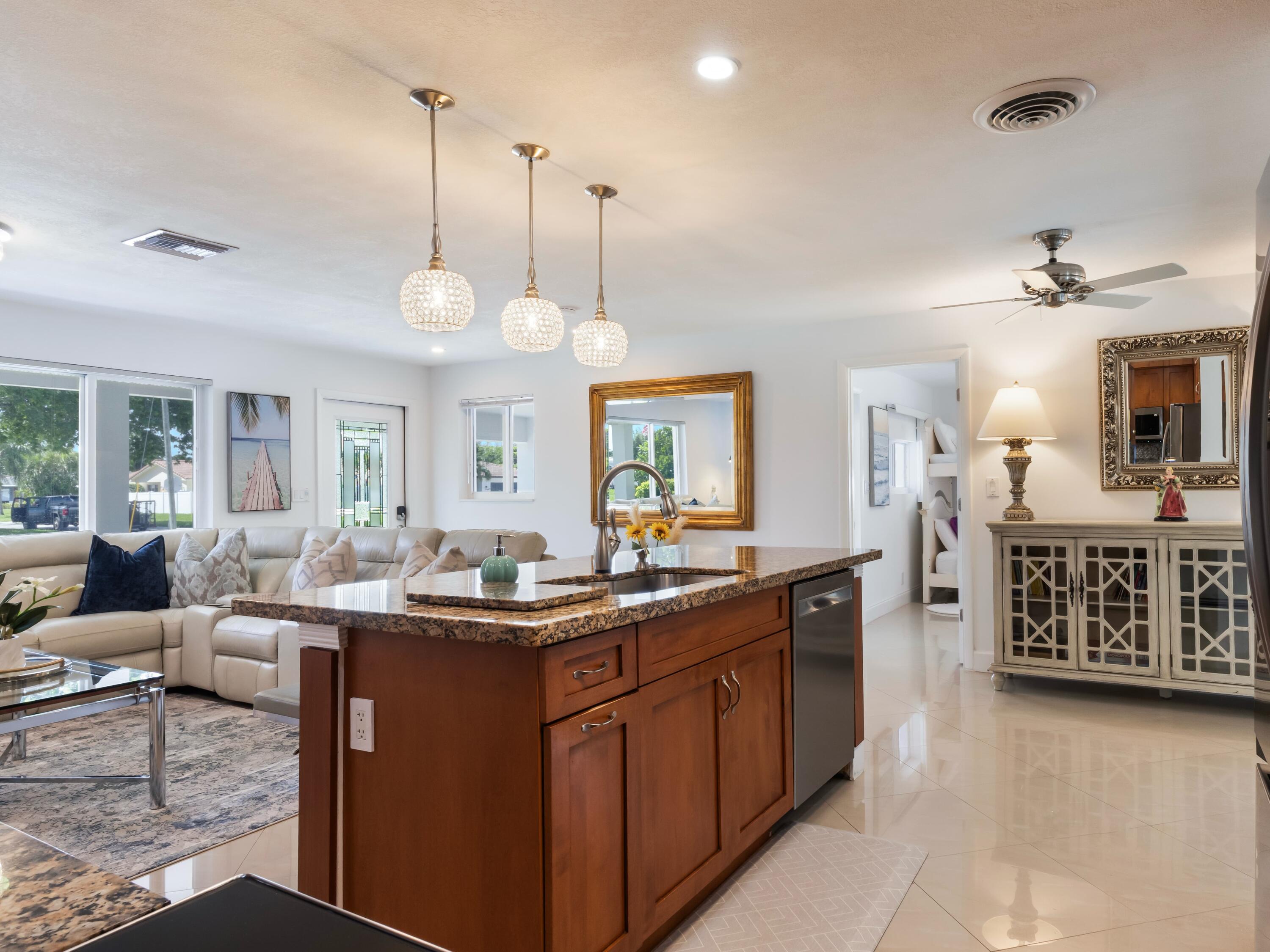 301 Northeast 23rd Street Boca Raton, FL 33431 - Photo 16 of 43 a view of a kitchen counter top space with sink and mirror