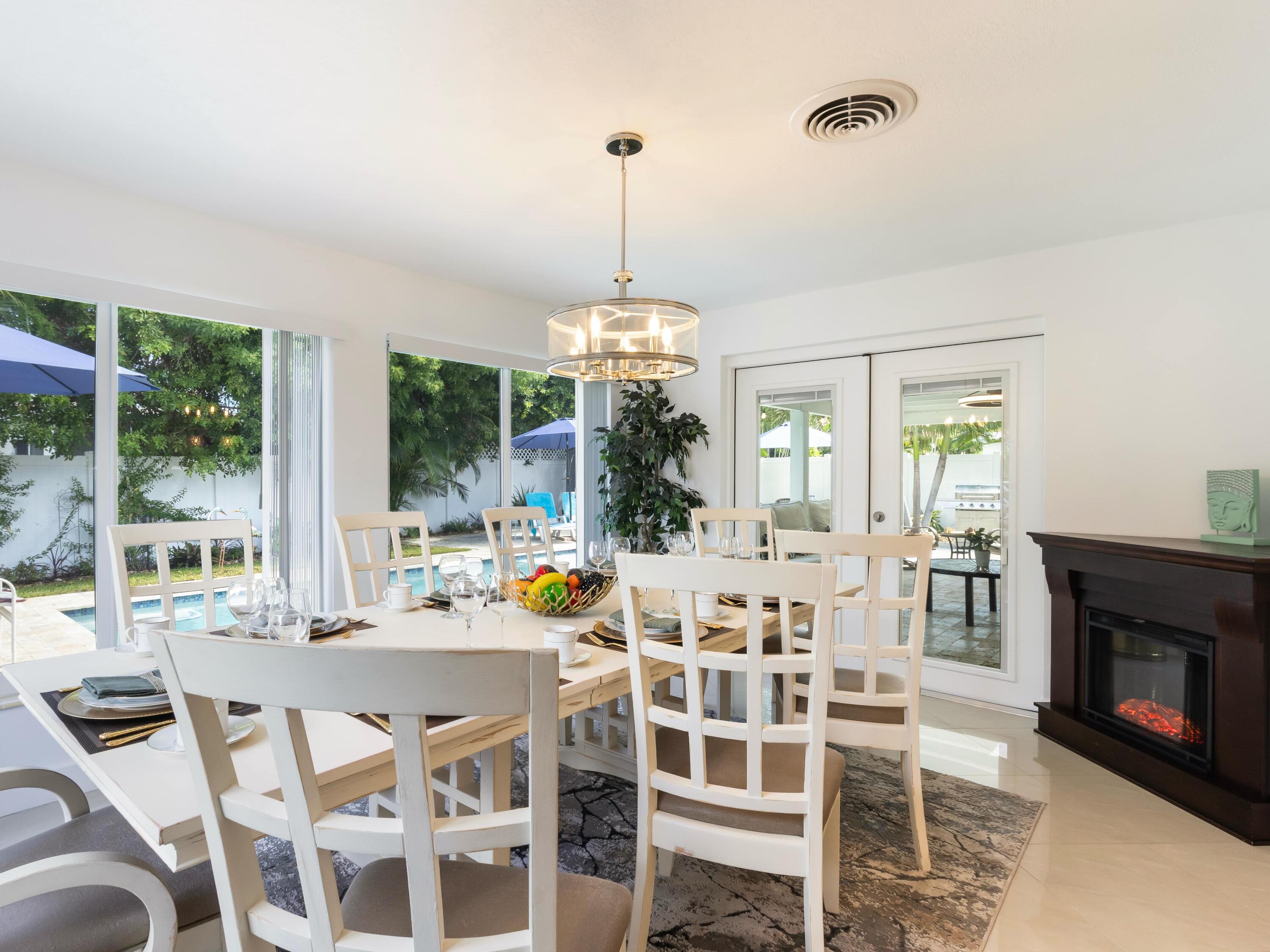 301 Northeast 23rd Street Boca Raton, FL 33431 - Photo 18 of 43 a dining room with a table and chairs