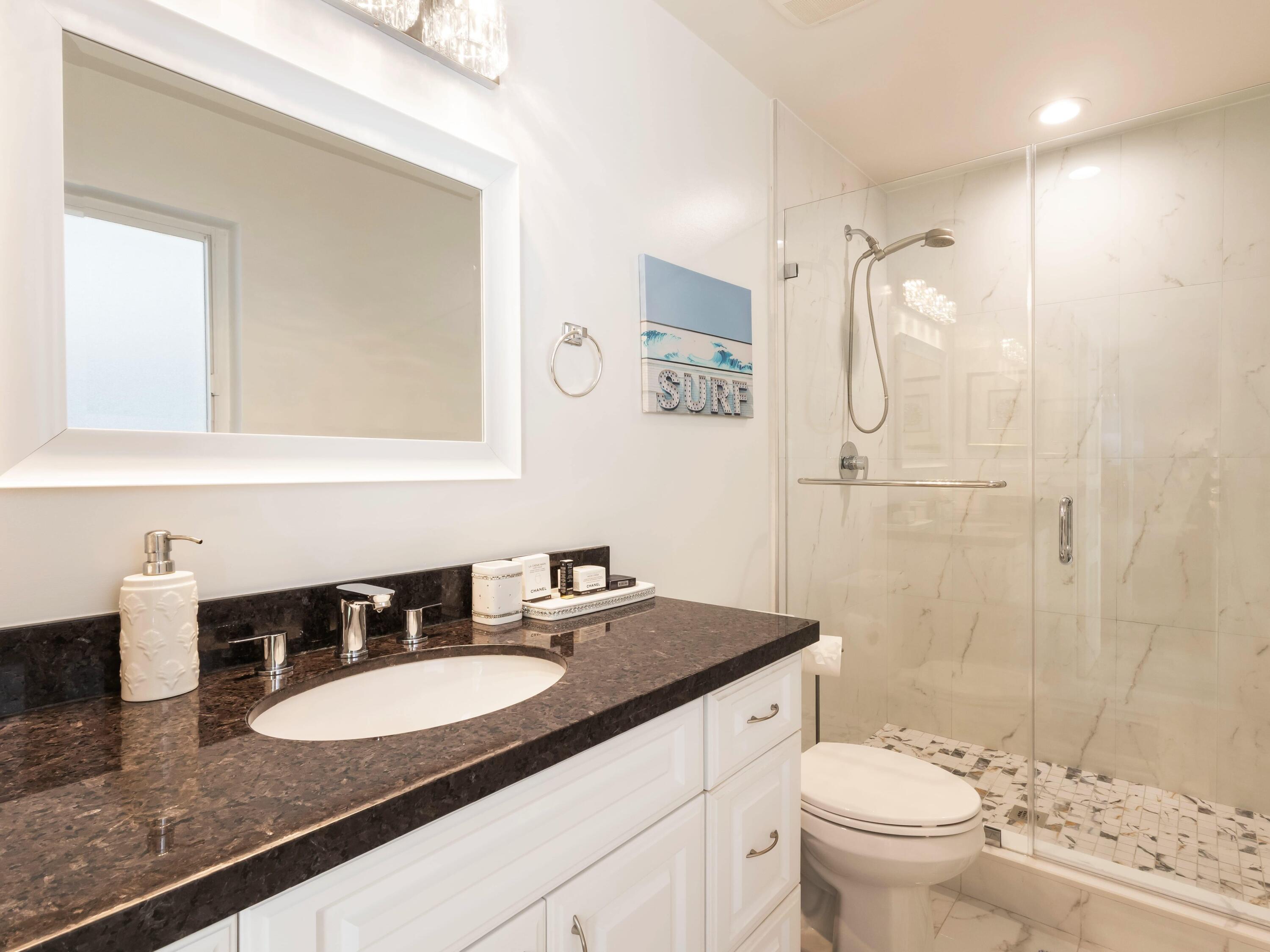 301 Northeast 23rd Street Boca Raton, FL 33431 - Photo 22 of 43 a bathroom with a granite countertop sink a toilet a mirror and shower