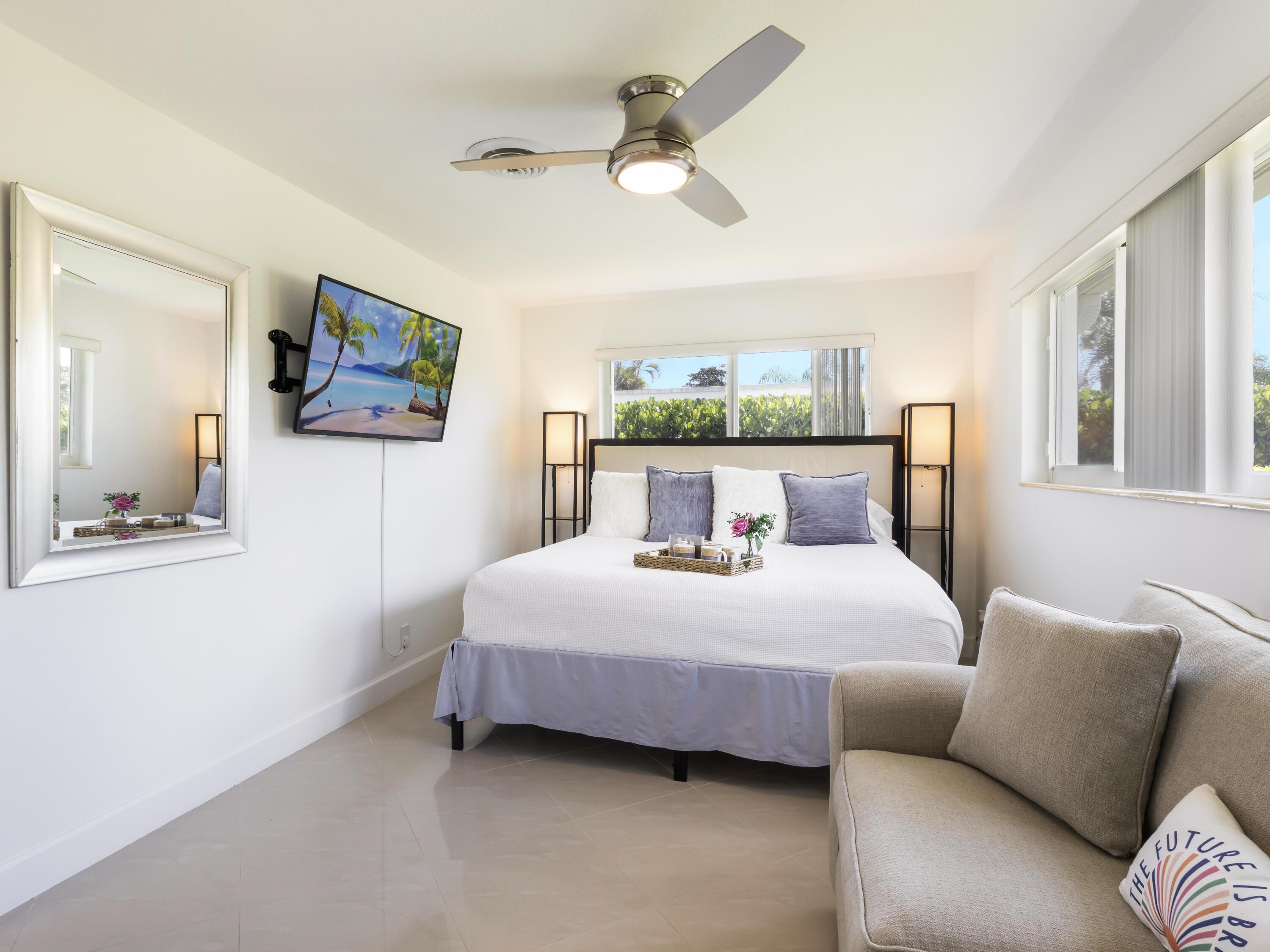 301 Northeast 23rd Street Boca Raton, FL 33431 - Photo 25 of 43 a bedroom with a bed painting on wall and a large window