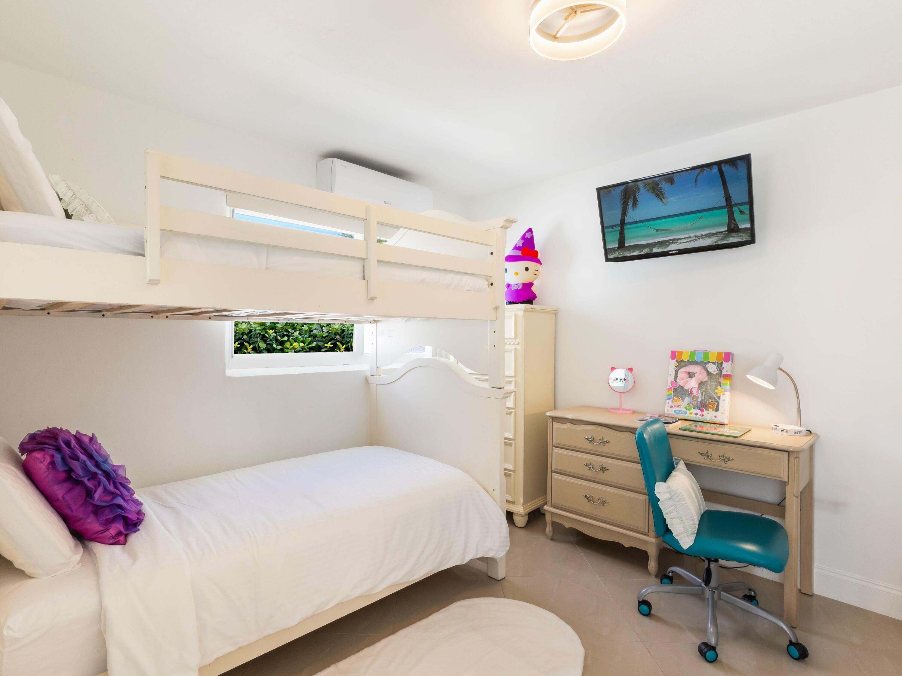 301 Northeast 23rd Street Boca Raton, FL 33431 - Photo 27 of 43 a bedroom with a bed a desk and chair