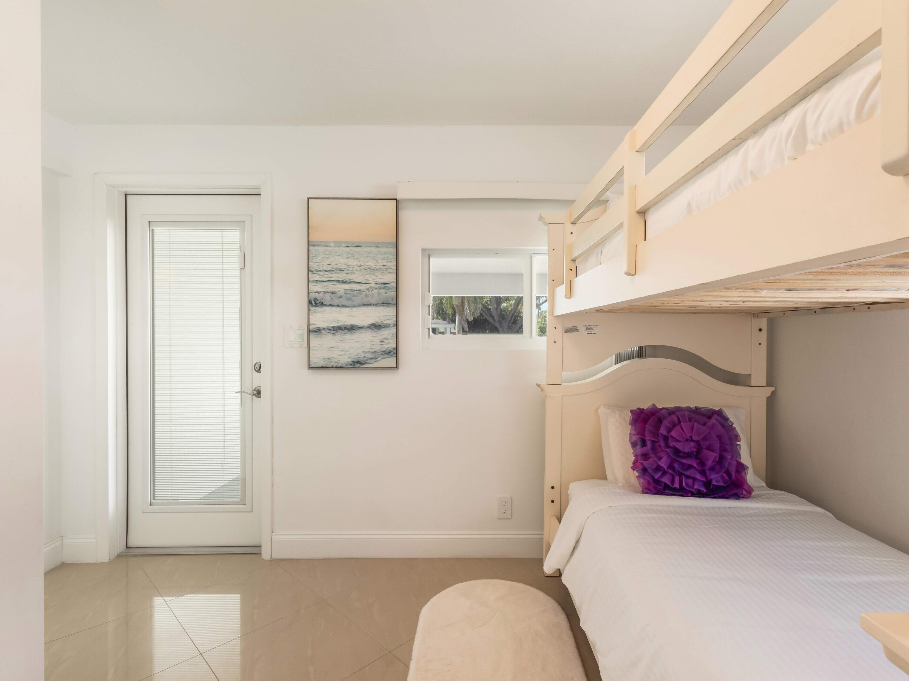 301 Northeast 23rd Street Boca Raton, FL 33431 - Photo 28 of 43 a bedroom with a bed and a window