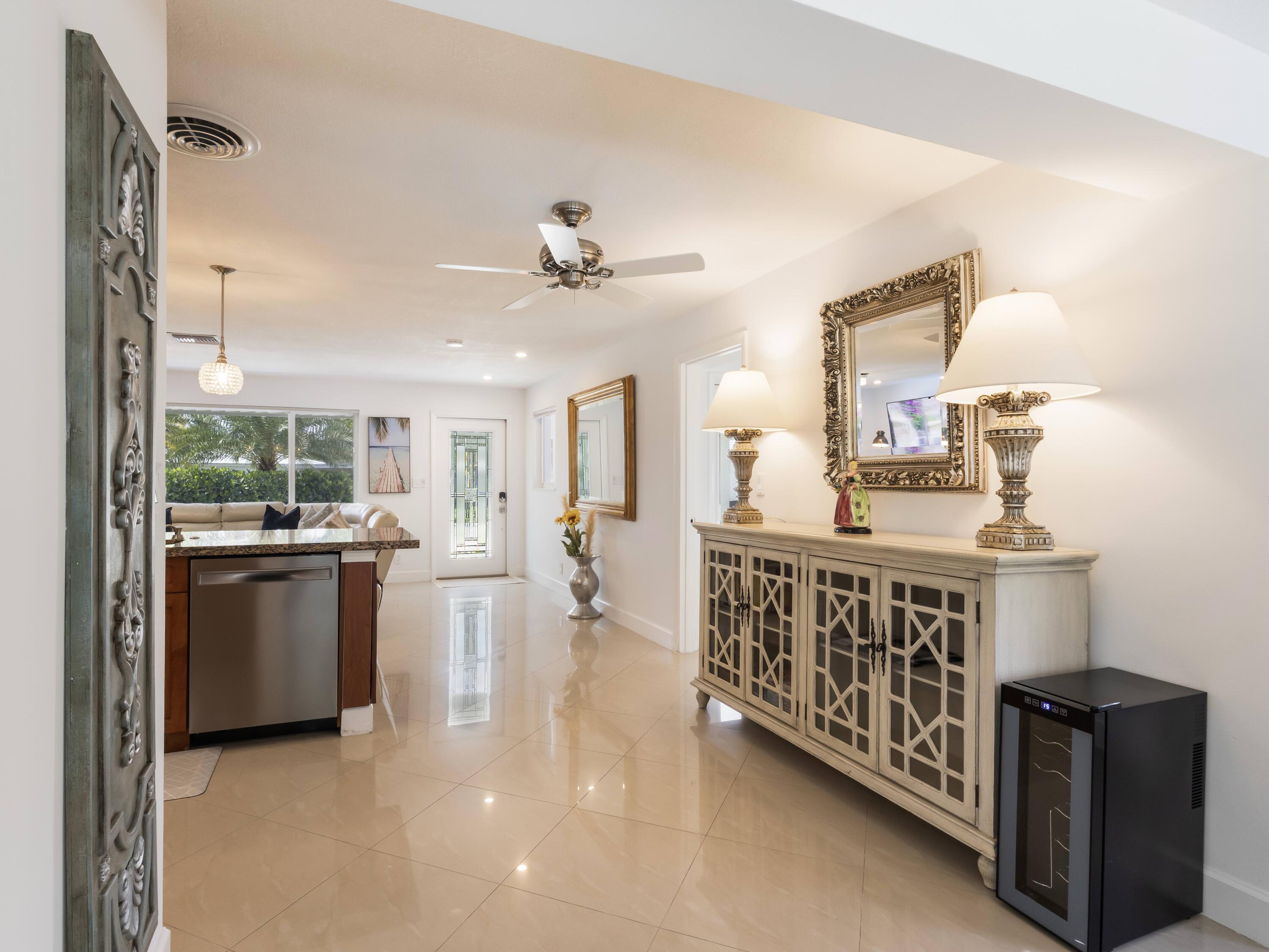 301 Northeast 23rd Street Boca Raton, FL 33431 - Photo 9 of 43 a kitchen with stainless steel appliances kitchen island a sink stove and cabinets