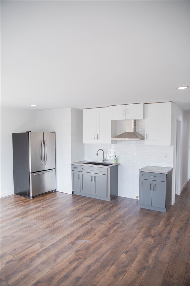 5908 Atlantic Avenue, Unit D Long Beach, CA 90805 - Photo 13 of 36 a kitchen with stainless steel appliances granite countertop a refrigerator sink and cabinets