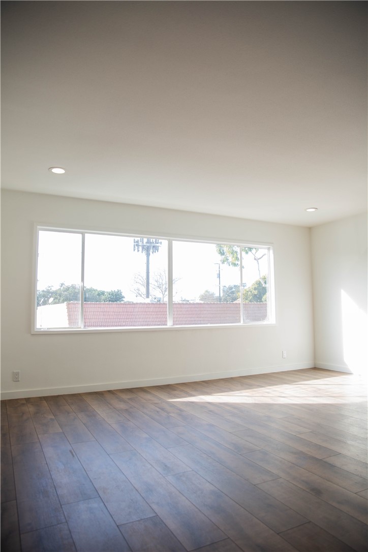 5908 Atlantic Avenue, Unit D Long Beach, CA 90805 - Photo 14 of 36 an empty room with wooden floor and windows