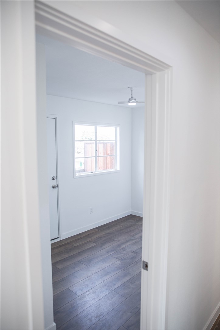5908 Atlantic Avenue, Unit D Long Beach, CA 90805 - Photo 17 of 36 a view of an empty room with wooden floor and a window