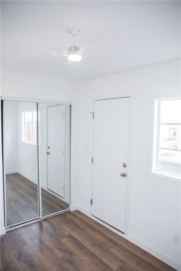 5908 Atlantic Avenue, Unit D Long Beach, CA 90805 - Photo 18 of 36 a view of an empty room with window and wooden floor