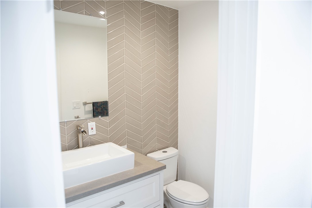 5908 Atlantic Avenue, Unit D Long Beach, CA 90805 - Photo 20 of 36 a bathroom with a sink a toilet and mirror
