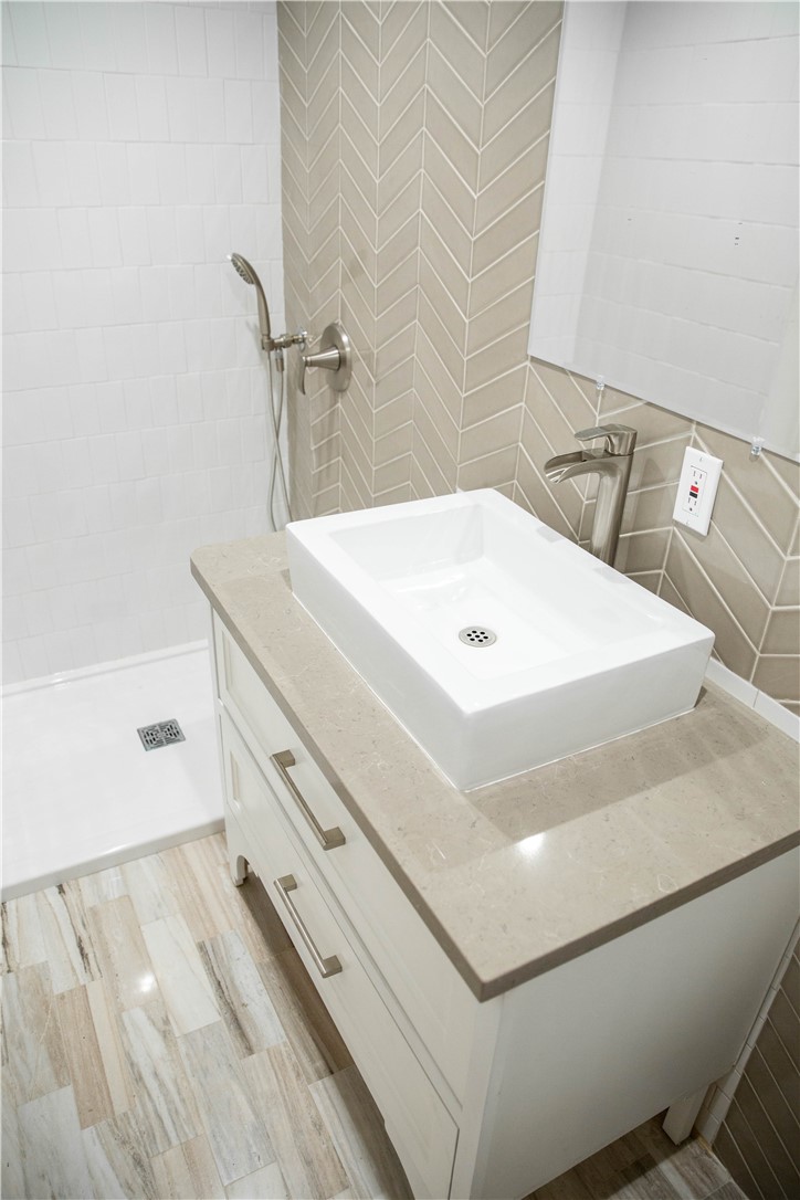 5908 Atlantic Avenue, Unit D Long Beach, CA 90805 - Photo 23 of 36 a bathroom with a sink and a mirror