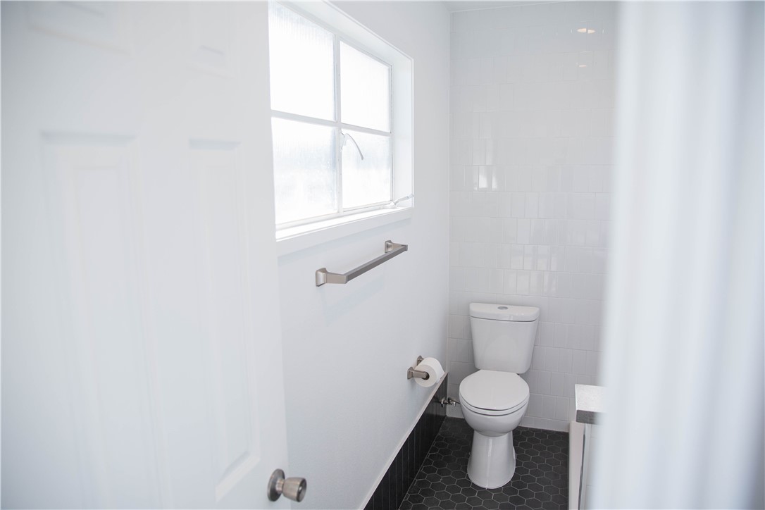 5908 Atlantic Avenue, Unit D Long Beach, CA 90805 - Photo 29 of 36 a bathroom with a toilet and a window