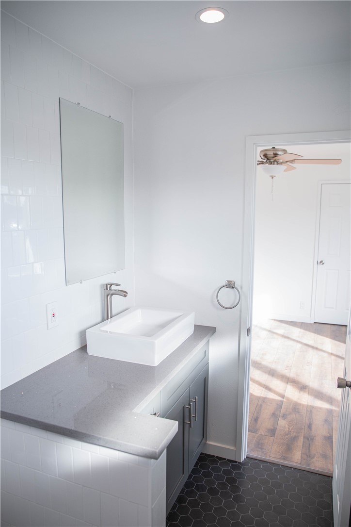 5908 Atlantic Avenue, Unit D Long Beach, CA 90805 - Photo 30 of 36 a bathroom with a sink and mirror