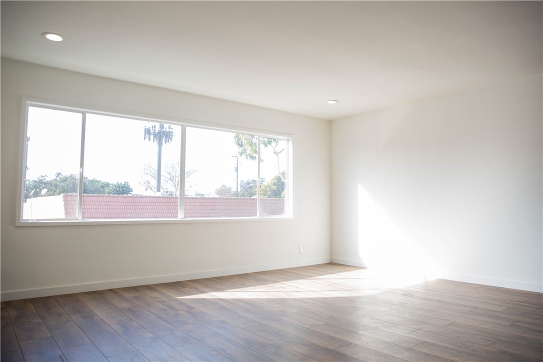 5908 Atlantic Avenue, Unit D Long Beach, CA 90805 - Photo 3 of 36 an empty room with wooden floor and windows