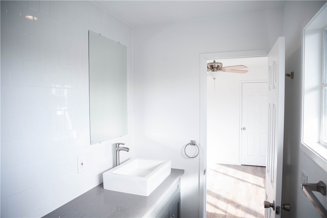 5908 Atlantic Avenue, Unit D Long Beach, CA 90805 - Photo 31 of 36 a bathroom with a sink a toilet and shower