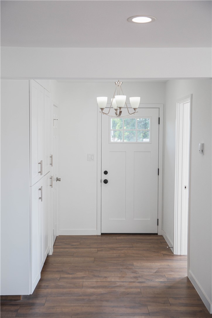 5908 Atlantic Avenue, Unit D Long Beach, CA 90805 - Photo 7 of 36 a view of an empty room with wooden floor and a window