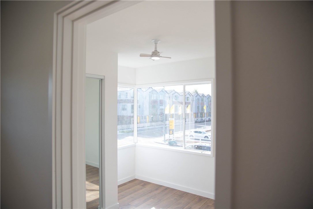 5908 Atlantic Avenue, Unit D Long Beach, CA 90805 - Photo 8 of 36 a view of an empty room with wooden floor and a window