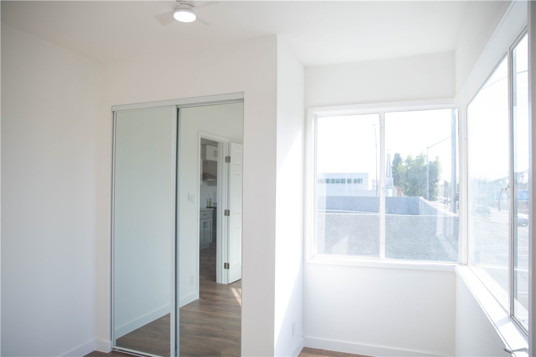 5908 Atlantic Avenue, Unit D Long Beach, CA 90805 - Photo 10 of 36 a view of wooden floor and windows in a room