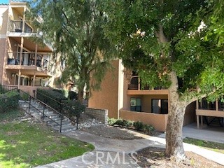 10655 Lemon Avenue, Unit 3401 Rancho Cucamonga, CA 91737 - Photo 4 of 27 front view of a house with a tree