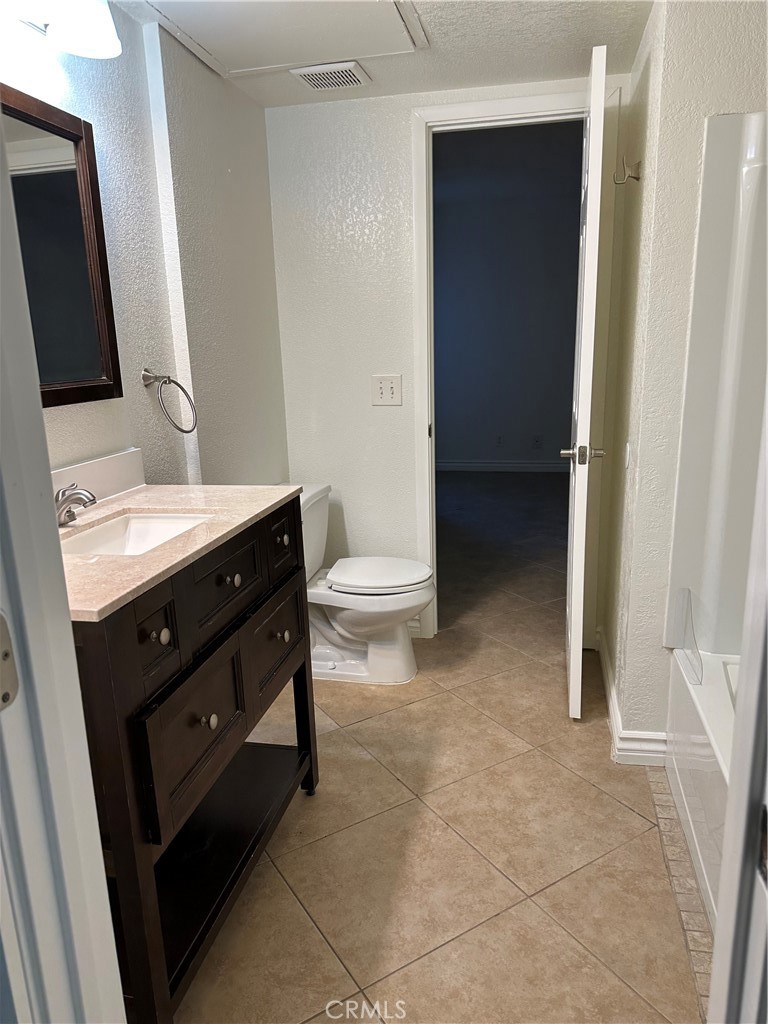 10655 Lemon Avenue, Unit 3401 Rancho Cucamonga, CA 91737 - Photo 8 of 12 a bathroom with a sink a toilet and mirror