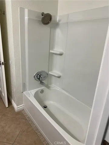 a view of a livingroom with an empty space and a hallway