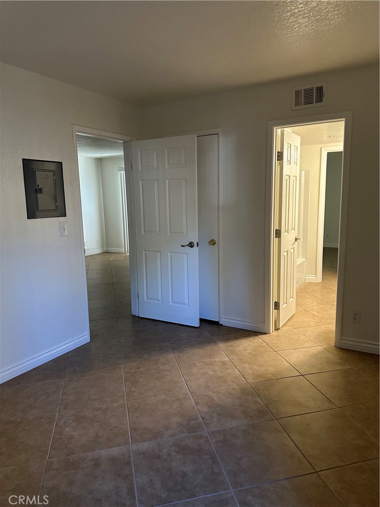 10655 Lemon Avenue, Unit 3401 Rancho Cucamonga, CA 91737 - Photo 10 of 12 a view of a livingroom with an empty space and a hallway
