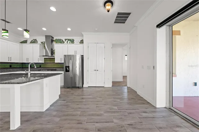 a front view of a house with a yard and potted plants